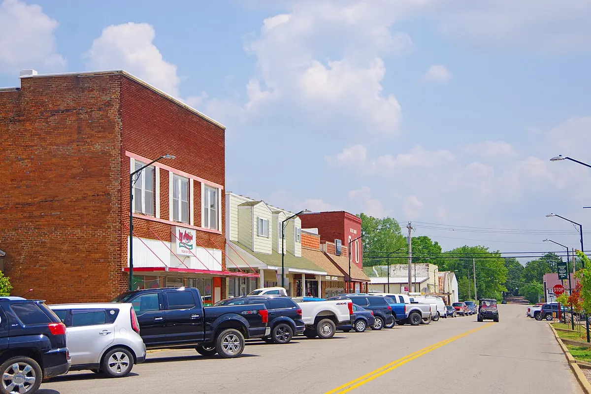 Pickup trucks parked along a brick storefront street in Mountain View, Missouri.